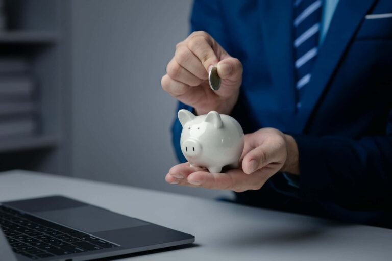 A person is holding a piggy bank, saving money and managing personal finances. Concept of increasing